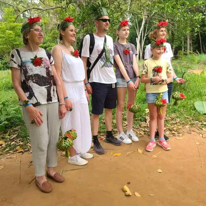 Guests on a spice farm tour wearing flower crowns
